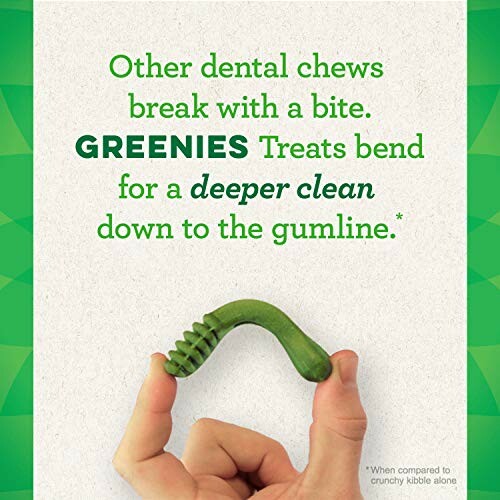 Greenies dental treat being bent by fingers, with text about deeper clean.