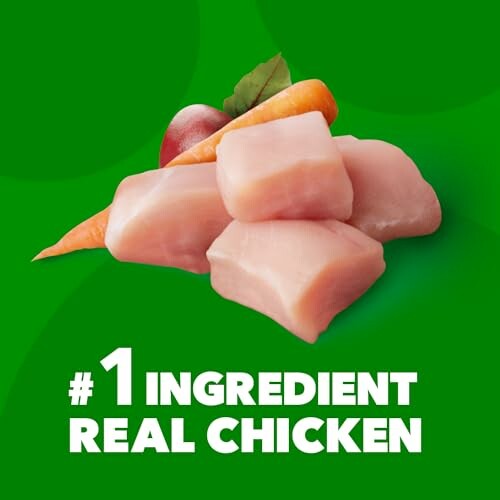 Chunks of raw chicken with carrot and tomato on green background, labeled #1 Ingredient Real Chicken.
